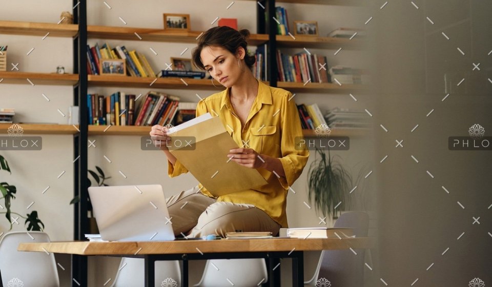 demo-attachment-468-beautiful-woman-in-shirt-sitting-on-desk-with-LE96BAG